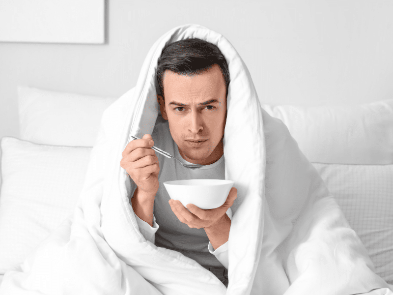 man sick and eating soup